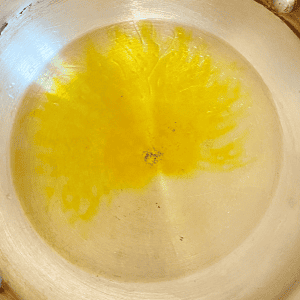 vegetable oil and mustard oil heating up in a skillet