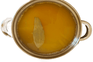 pot with masoor dal, turmeric, water, and whole bay leaves