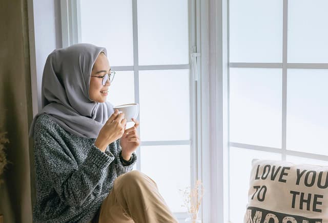 woman drinking coffee and feeling less stress