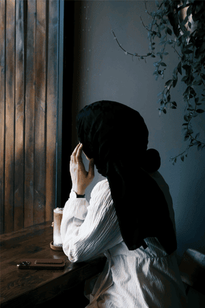 Overwhelmed Muslim mom pausing for a quiet moment of calm at home